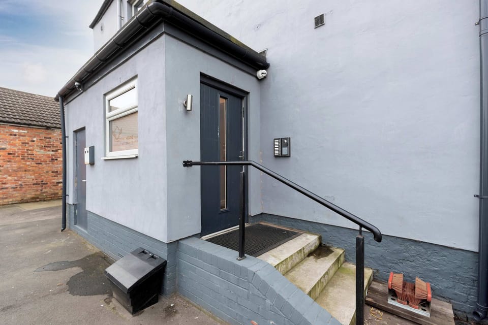 A well-maintained property exterior with a private entrance, raised steps, secure handrail and modern exterior finishes, creating a neat and welcoming arrival for guests.