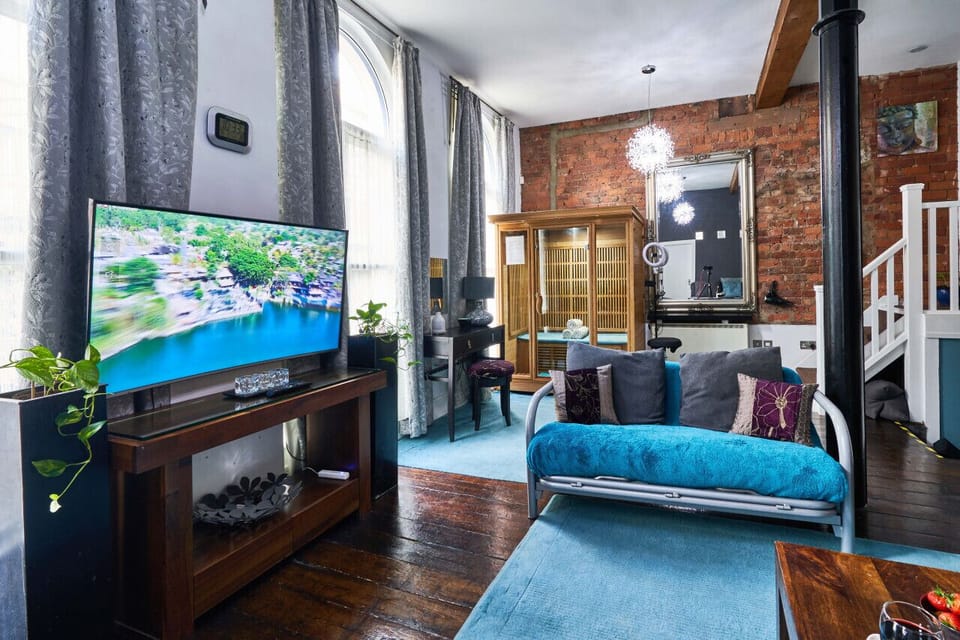 Open Plan Lounge: Relax in a vibrant space with a sleek TV and soothing sauna retreat!