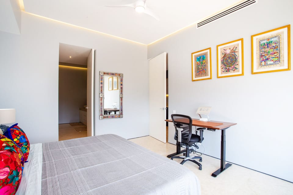 The elegant master bedroom can be conveniently used as your private office as well
