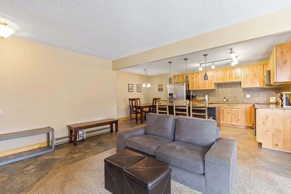 Seating in front of the wood-burning fireplace and open kitchen