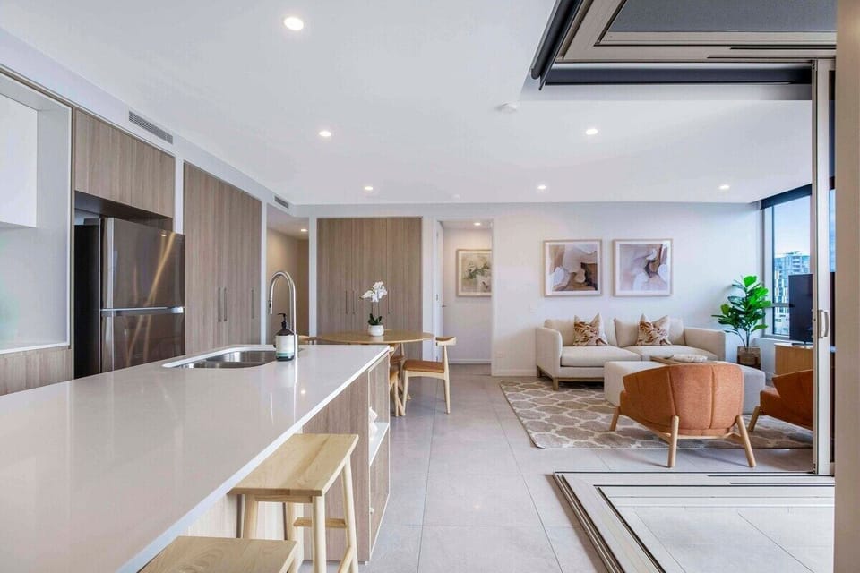 Full gourmet kitchen overlooks the living area with a stove, oven, refrigerator.