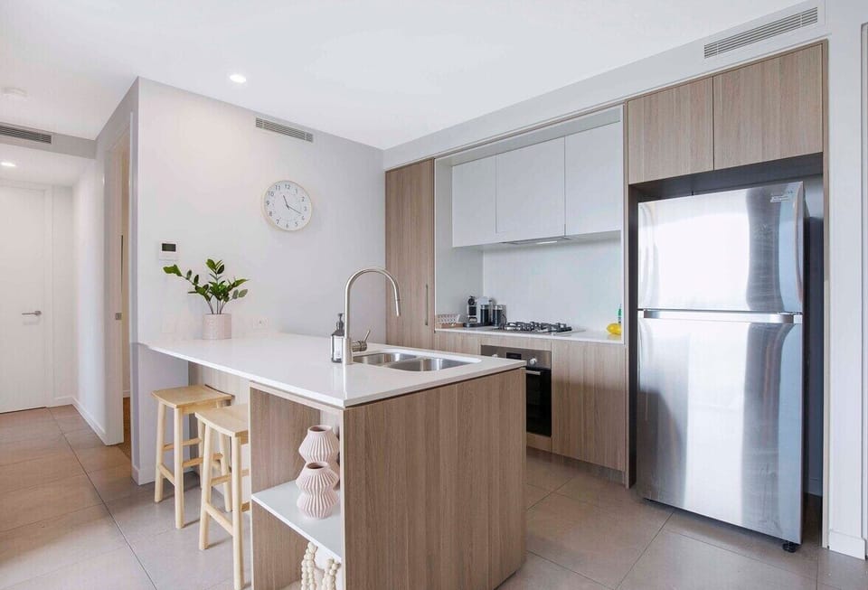 Full gourmet kitchen overlooks the living area with a stove, oven, refrigerator.