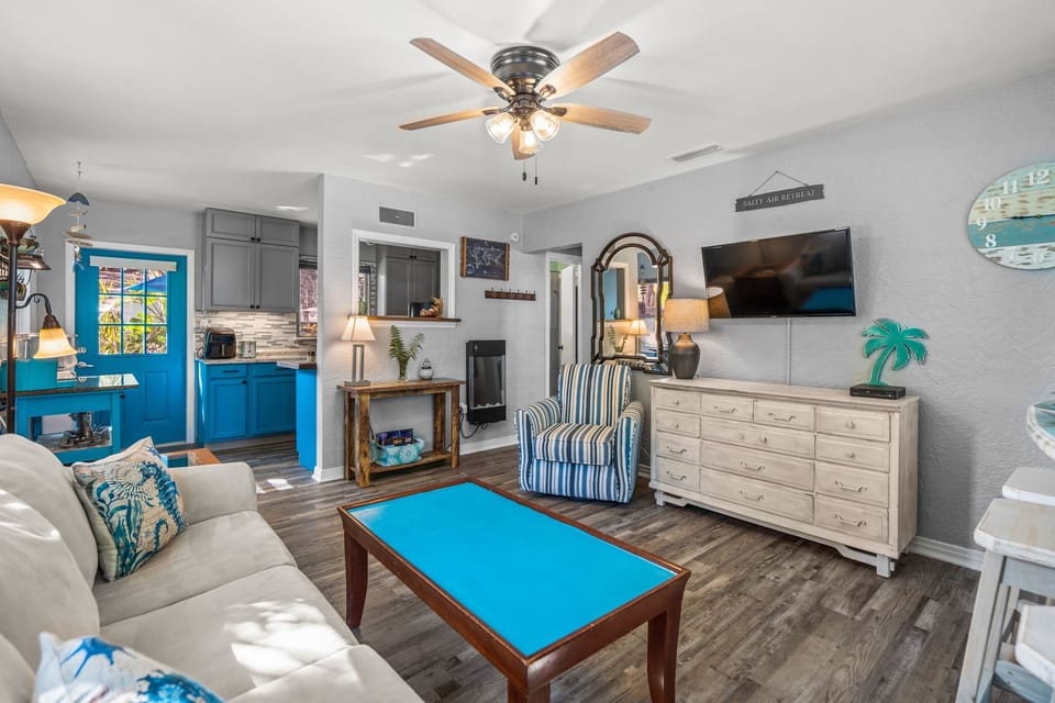 The living room has a queen size sleeper sofa and dresser for extra storage.