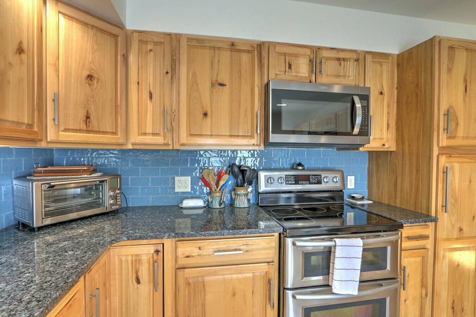 Kitchen with stainless steel appliances and stone countertops
