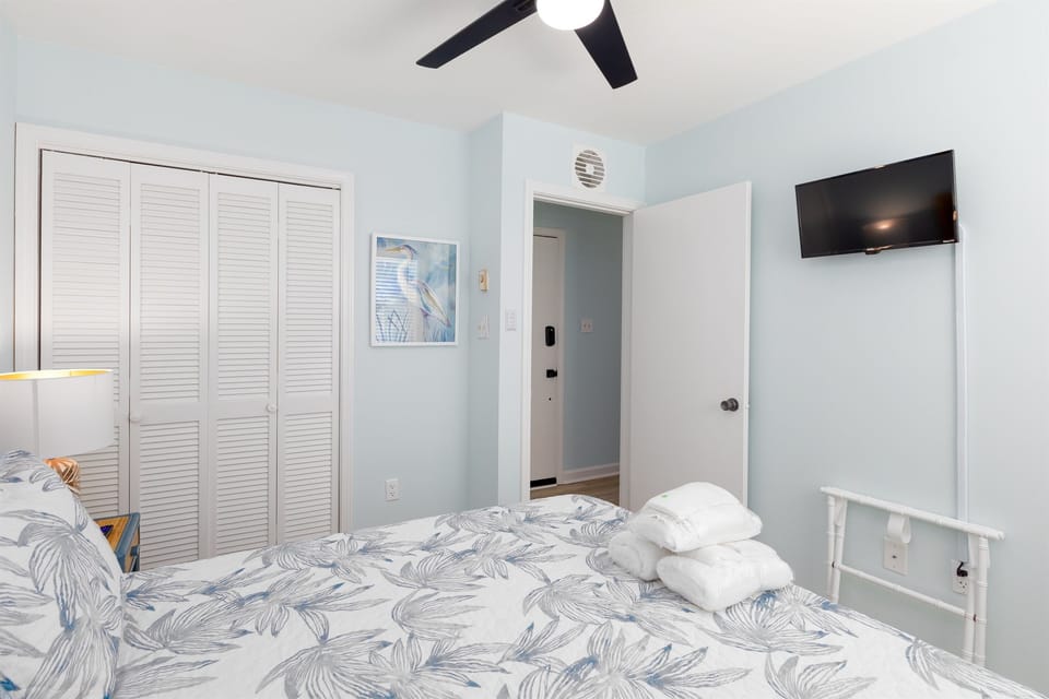 TV and luggage rack in bedroom