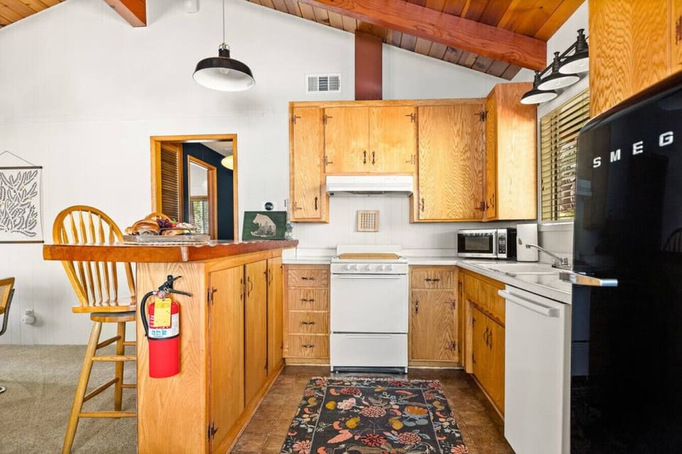 The kitchen you will find stocked with all the necessary cookware, utensils, and tableware, making it convenient for guests to prepare and enjoy home-cooked meals.