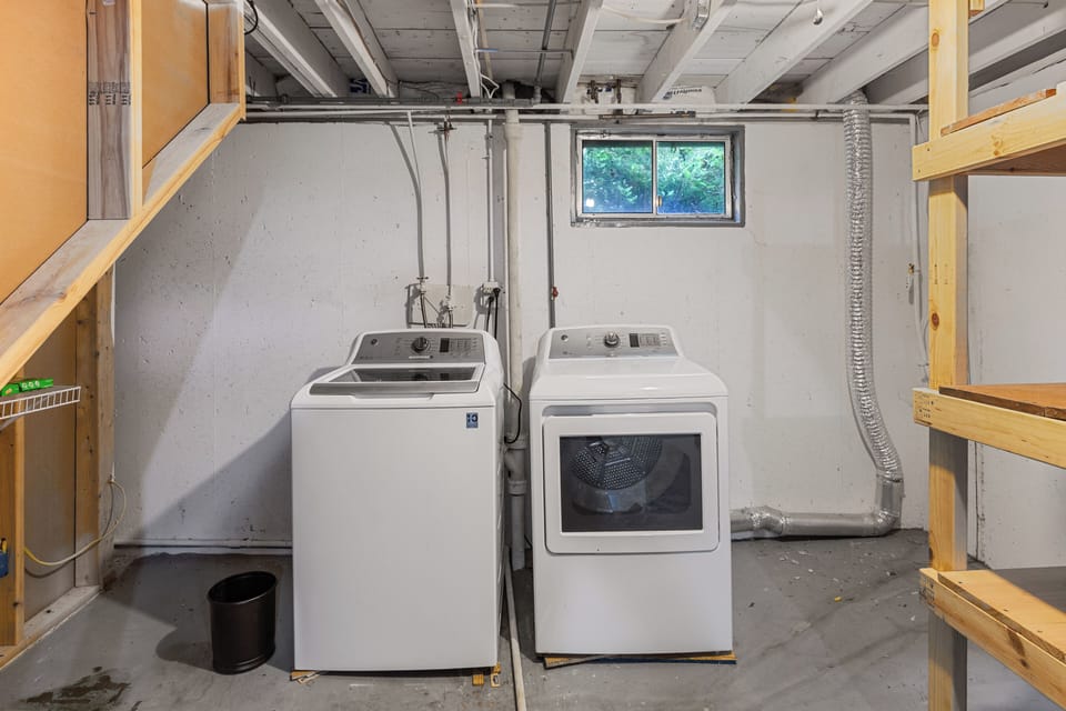 Private basement laundry area with a full-size washer and dryer for guest use.