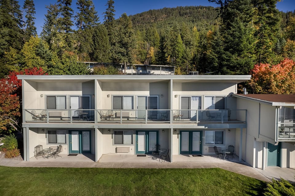 The lower-level patios open onto the lawn, a short walk from the water.