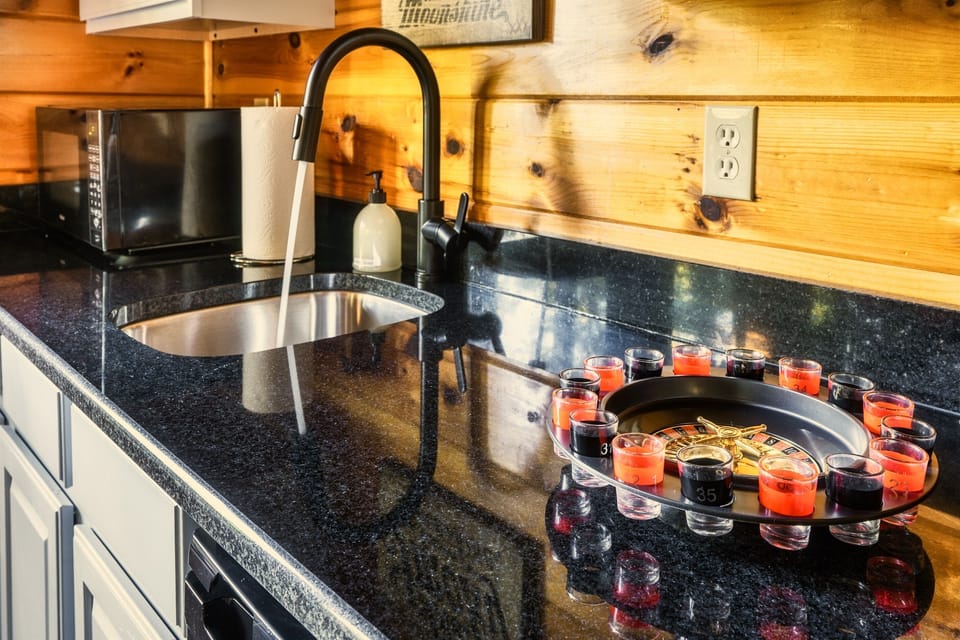 The wet bar provides convenience to the lower level, and also houses all of our board and card games, including roulette.