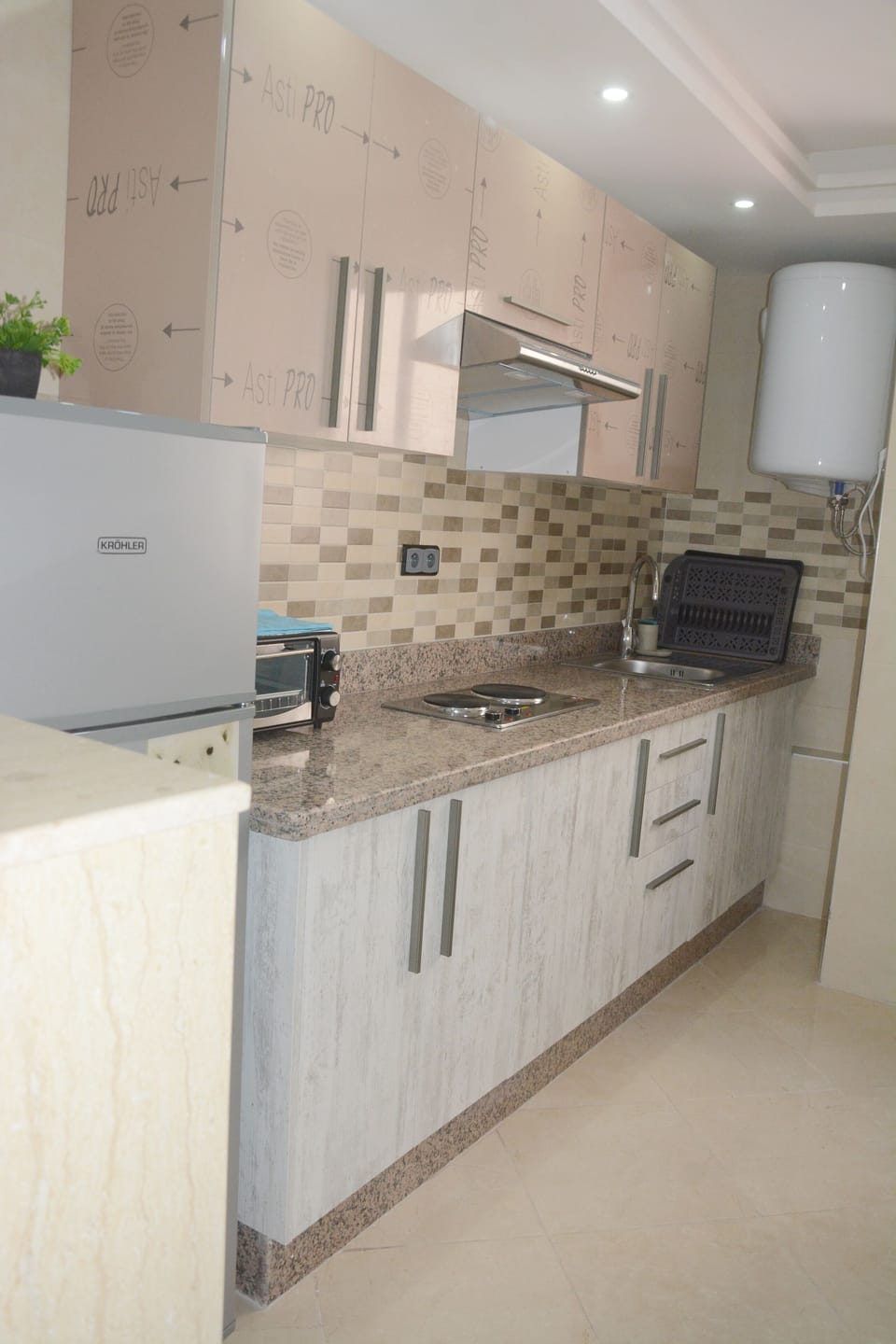 Full-size fridge, cookware/dishes/utensils, cleaning supplies