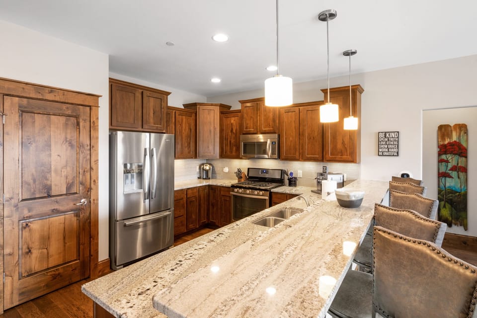 Open concept full kitchen with two coffee makers. Keurig and an espresso maker.