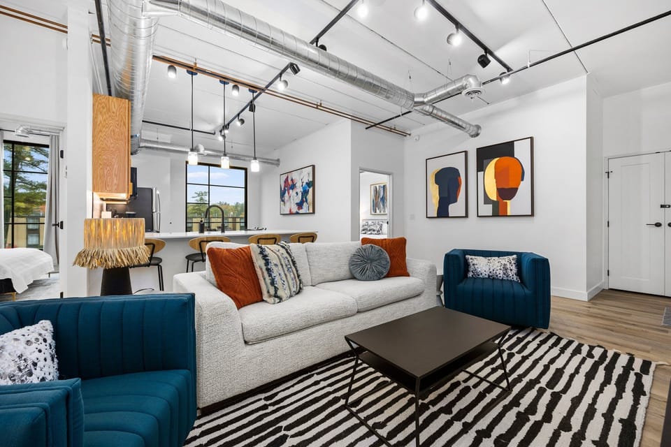 Step into this bright, open-concept retreat where morning light fills the room, inviting you to sink into the sofa or sleep into this queen-sized sofa bed with a book and watch the city come alive through the windows.