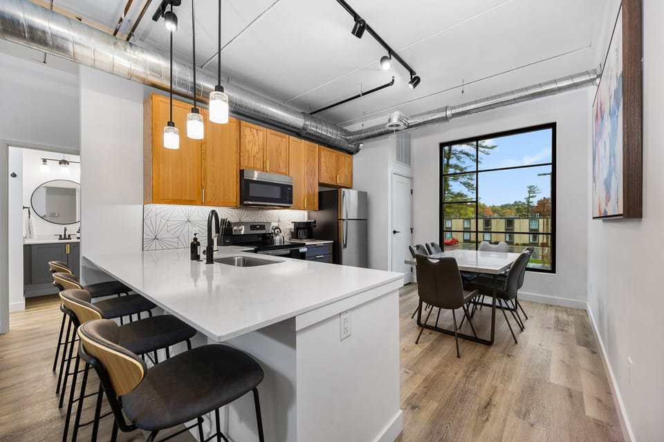 Prepare a gourmet meal in this fully equipped kitchen, where modern finishes and wide windows make every cooking moment feel inspired, featuring brand new stainless steel appliances, ample counter space, and a bright dining area that comfortably seats six.