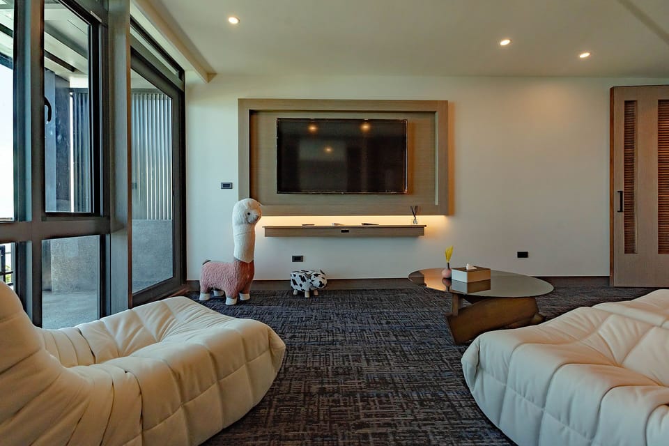 Standard Quadruple Room | Living area | 32-inch flat-screen TV with digital channels