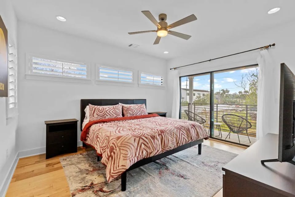 Primary bedroom with king bed and balcony