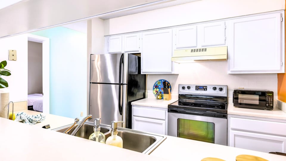 A crisp kitchen with stainless appliances for cooking in.