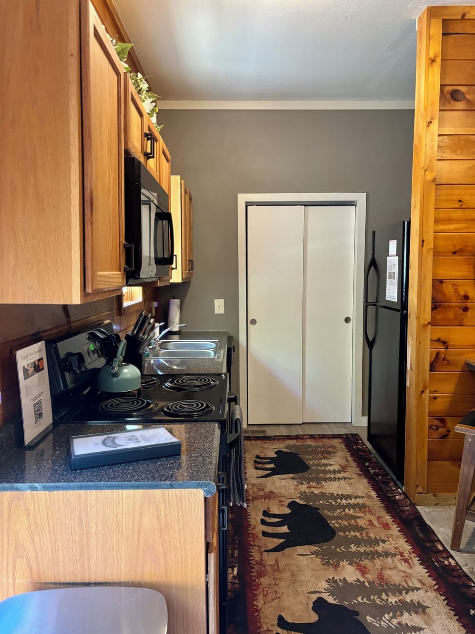 The kitchen is stocked with all necessary pots, pans, and utensils.