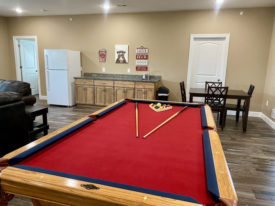 Upper level living area with 3 full size couches, a 75" HD Smart TV, & Local Cable, near the pool table & wet bar!