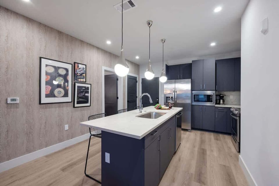 Fully equipped kitchen stocked with your basic cooking essentials. Includes stainless steel appliances, kitchen island, coffee machine, and toaster.