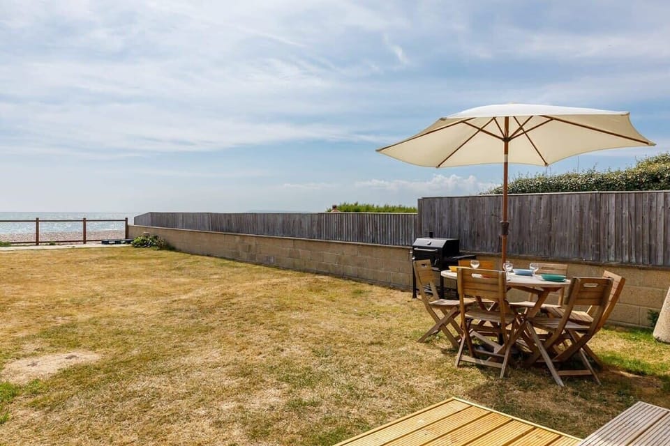 The garden has a BBQ, dining furniture and sun loungers. Enjoy uninterrupted sea views and dazzling sunsets from the comfort of your own garden.