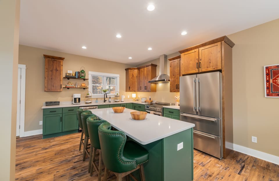 Designer decorated kitchen with high-end appliances, large eat-in island with Granite Counters