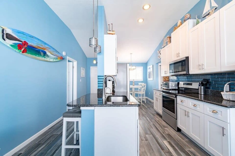 Modern kitchen with blue walls and granite countertops