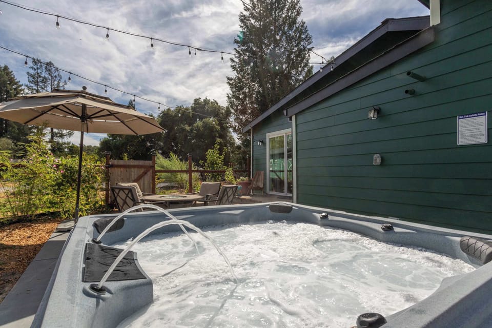 Unwind in the hot tub and soak up the peaceful backyard vibes.