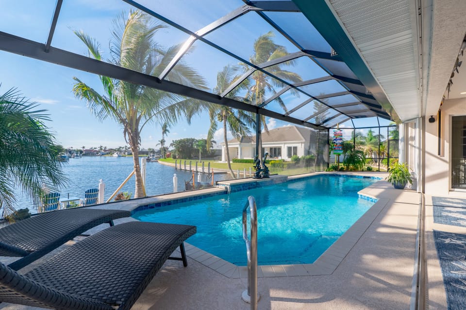 Wake up and swim your laps in our long lap style pool ! Beautiful pool deck area with 4 loungers to lay out and get that perfect Florida tan ! With long canal view with 4 beautiful mature coconut palm trees and 2 triple Christmas palms. Our property has over 7 species of palm trees ! 