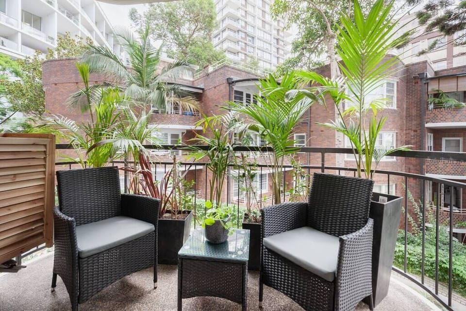 Relax on the balcony overlooking the luscious tropical gardens that frame a glimpse of the harbour.