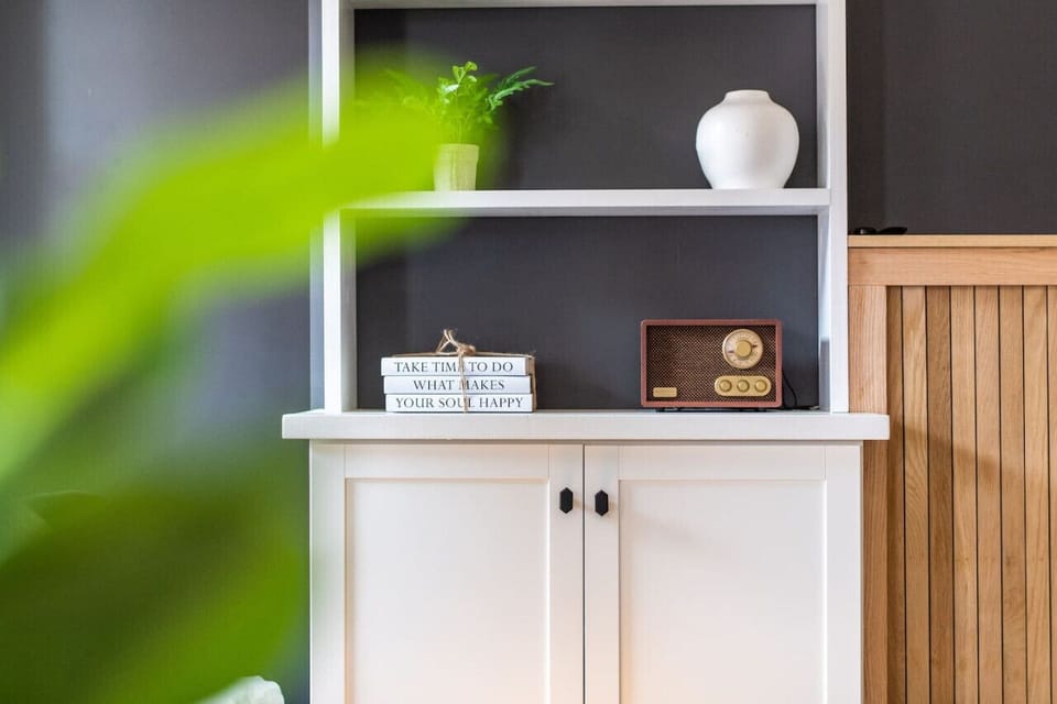 White cabinet with open shelving and decor