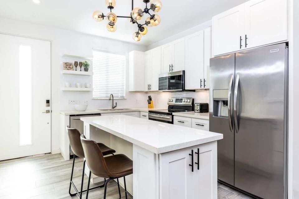Kitchen is equipped with stainless steel appliance and cooking basics.