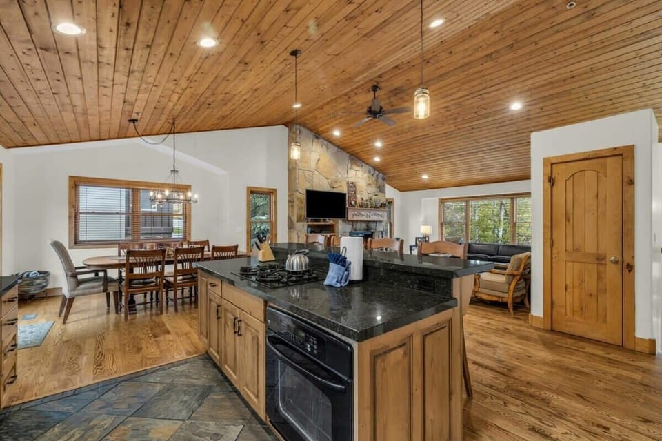 The home features an open-concept layout allowing for easy interaction between the kitchen, living, and dining areas.