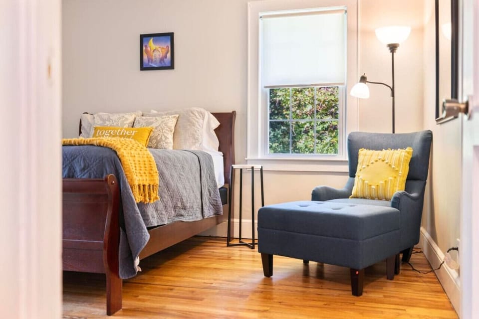 Cozy and inviting, this bedroom features a queen bed and a lounge chair, creating a perfect spot for rest and relaxation.