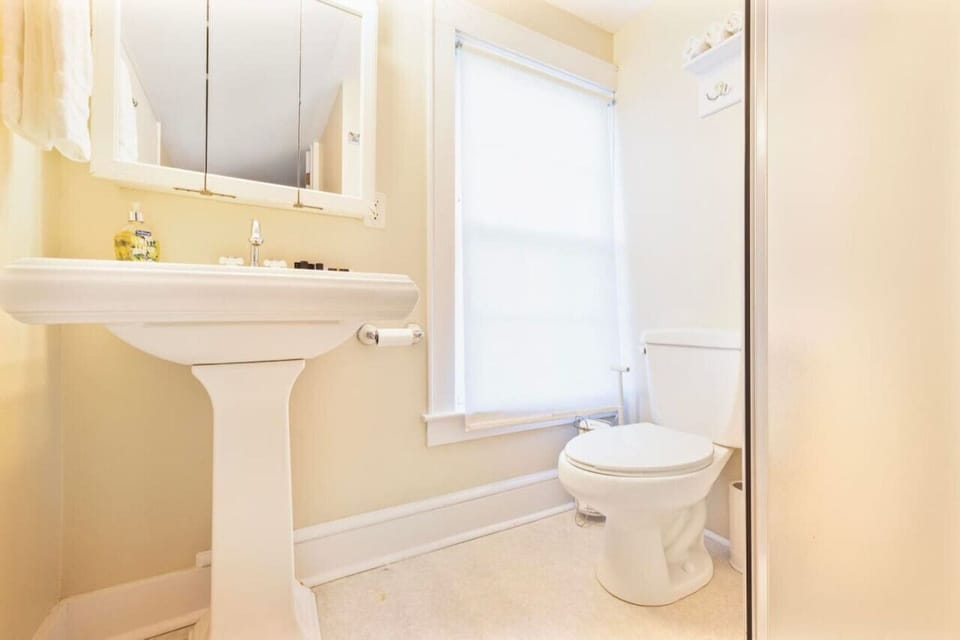 Charming and functional, the upstairs bathroom offers everything you need for a relaxing stay.