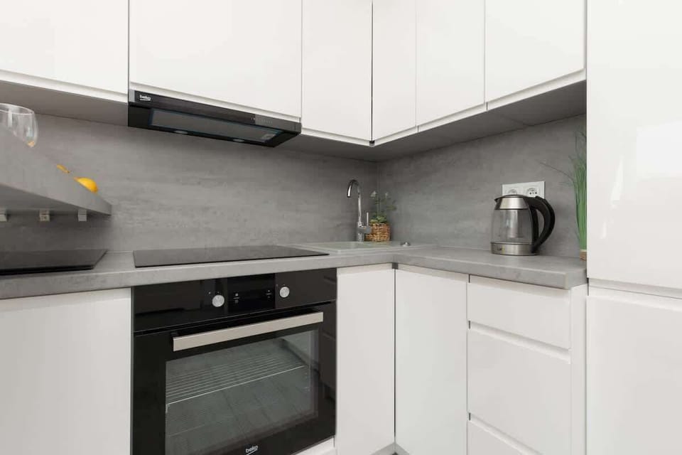 Kitchenette with plenty of kitchen utensils and dishes. 