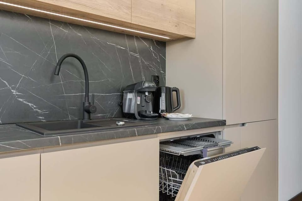 Kitchenette with plenty of kitchen utensils and dishes. 