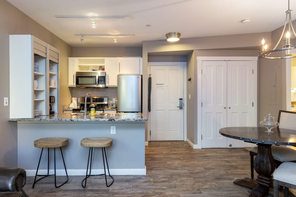 Your modern kitchen opens to the dining area, where granite countertops and bar seating create the perfect space for morning coffee or evening conversations.