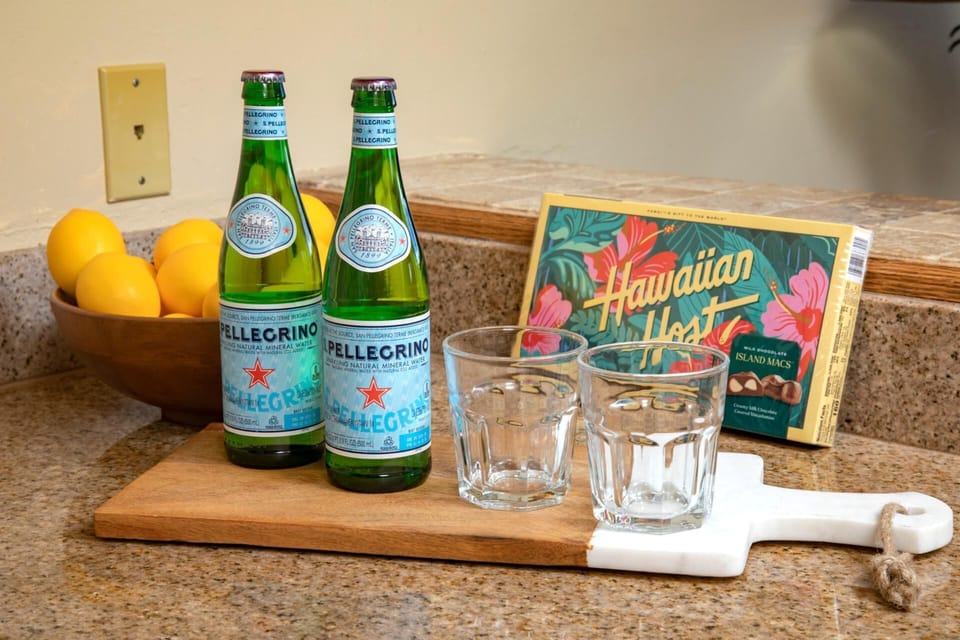 A sweet island welcome—refresh with chilled sparkling water and indulge in local chocolate-covered aloha   