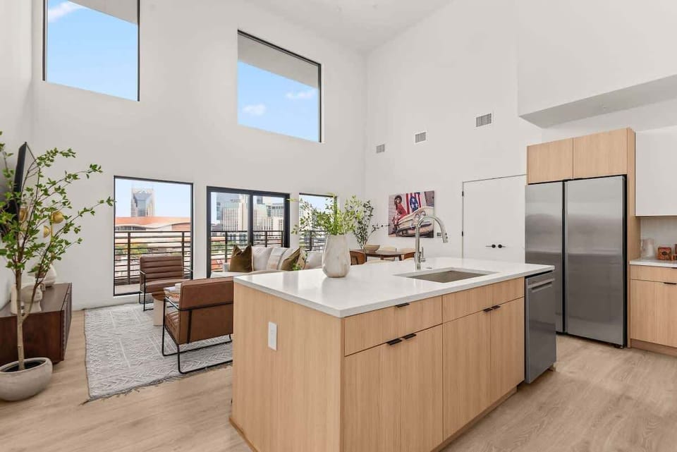 Spacious and grandiose living space with 20+ ft ceilings & many windows