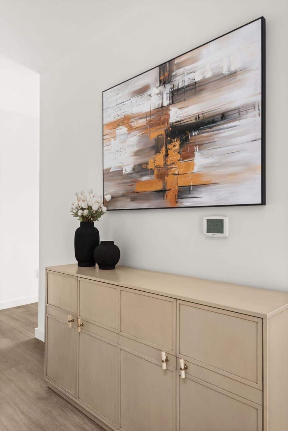 Modern entryway with statement art and stylish console.