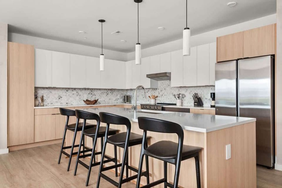 A fully equipped kitchen, stocked with coffee, tea, and condiments, along with a dining table to enjoy homemade meals.