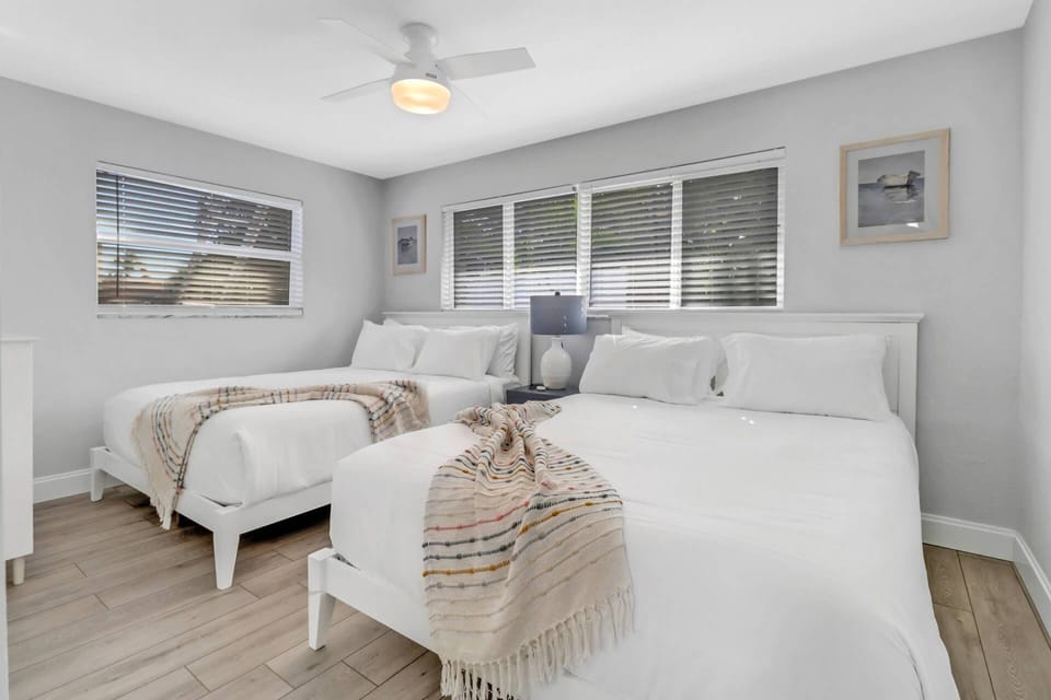 A pair of queen-size beds are in the 4th bedroom, where up to 4 guests can sleep.