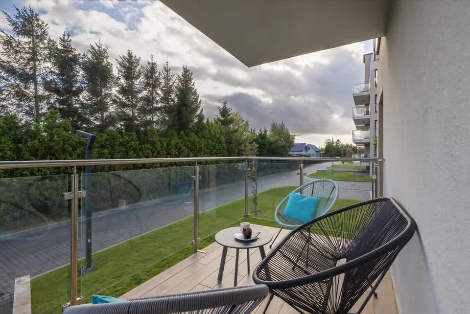 Another balcony perspective overlooking greenery and a calm neighborhood.

