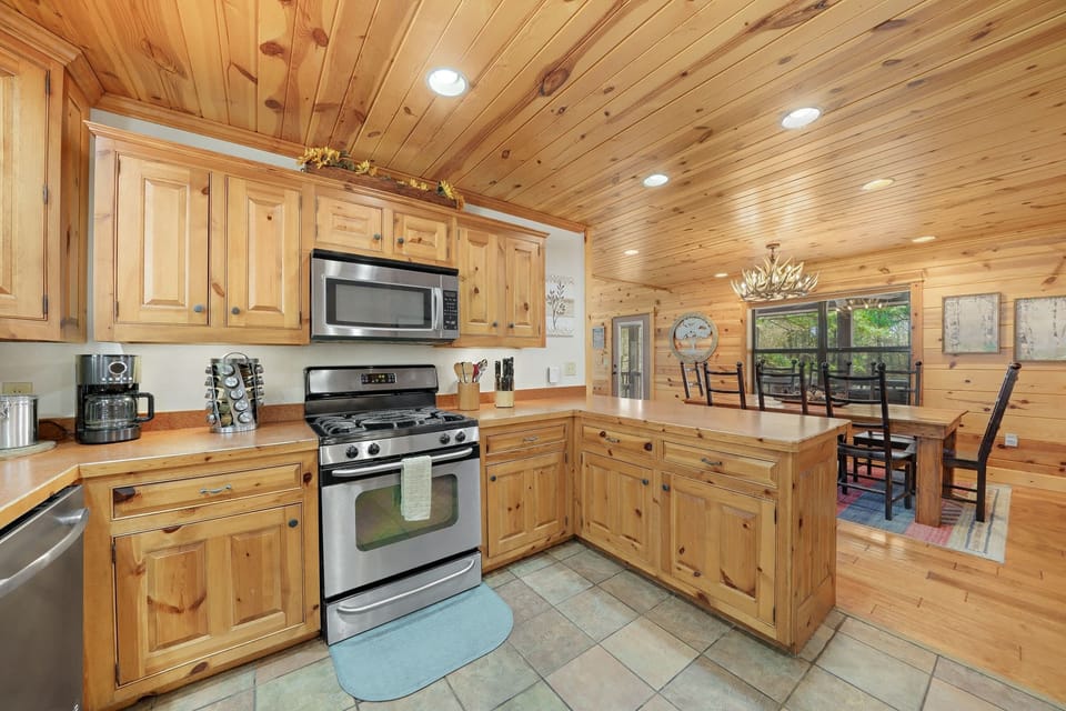 The fully equipped kitchen includes modern stainless steel appliances and cooking essentials.