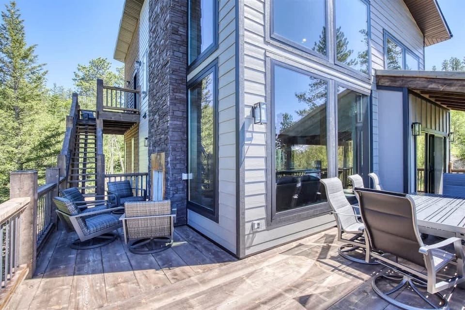Main level deck with gas BBQ grill, patio furniture, and an outdoor fireplace