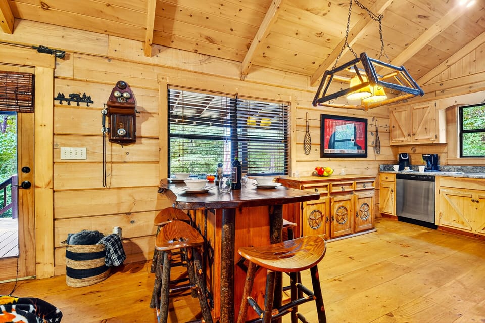 Cook, laugh, and connect in the heart of this Blue Ridge cabin rental with a bright, modern kitchen and dining area