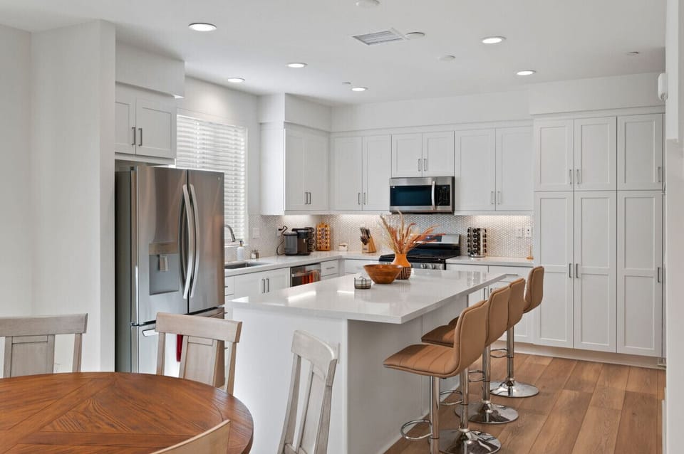 Modern kitchen w/ large island, bar seating & stainless appliances for easy meals