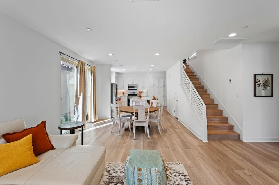 Open living & dining area w/ cozy seating, wood floors & easy flow to the kitchen