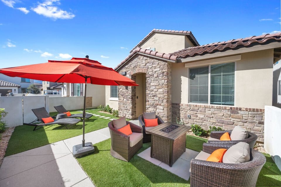 Private patio corner w/ lounge seating & umbrella, perfect for relaxing outdoors