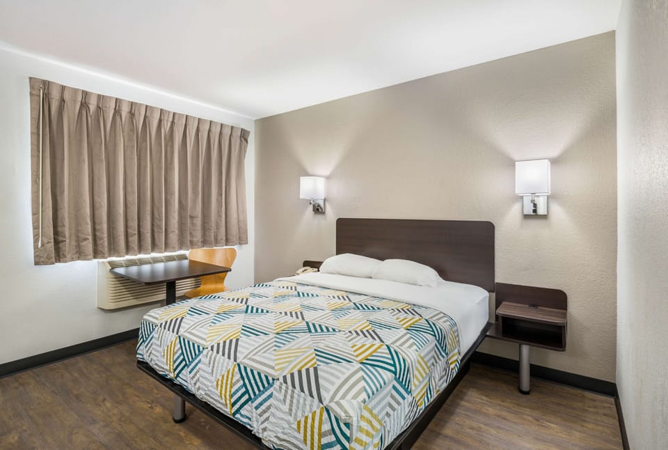 Desk, laptop workspace, bed sheets